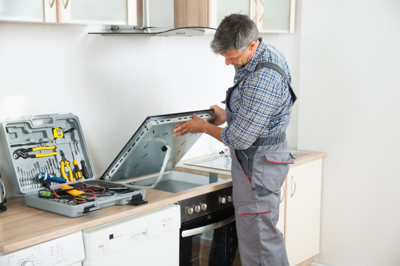Pegasus Appliance Repair technician performing stove and cooktop repair in a Southern Ontario kitchen