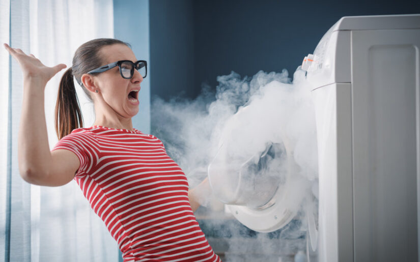 Scared woman and burning appliance at home