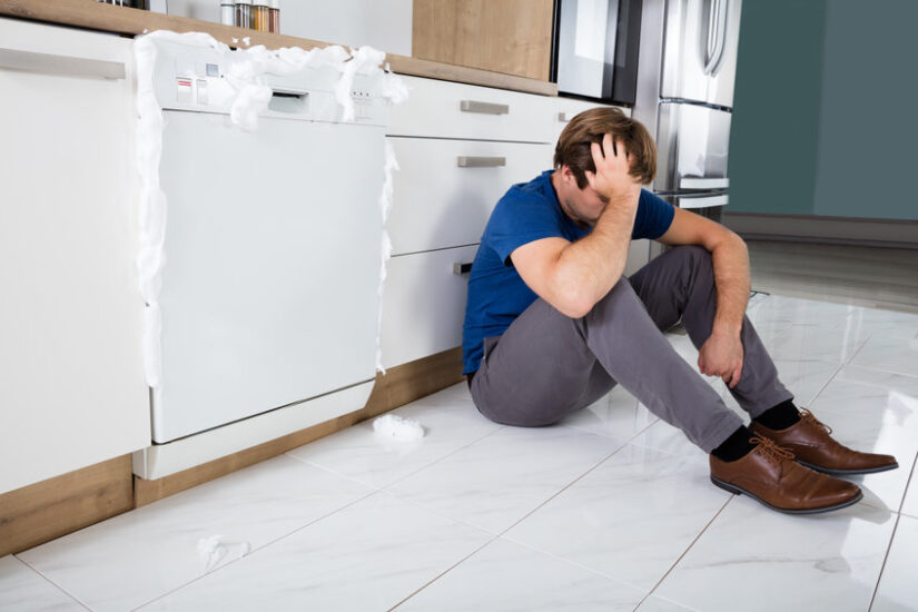 Man Sitting Next To Dishwasher