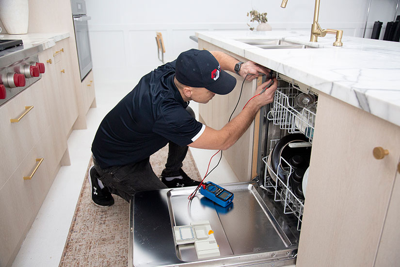 PegasusAppliance Repair technician fixing appliance in London