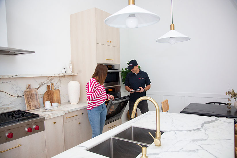 Pegasus Appliance Repair technician in Oakville's house talking to customer