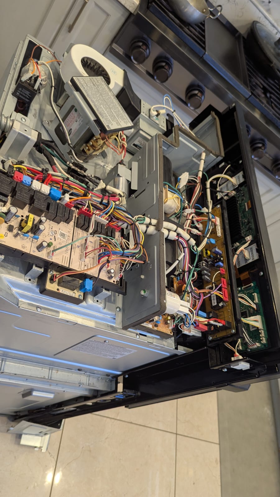 Slide-in oven disassembled showing relay control board