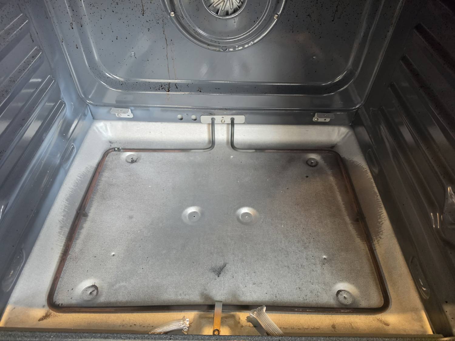 Failed bake element removed from electric range oven